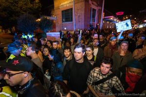 Protesters stand off with Police Officers as they try to continue their stopped protest