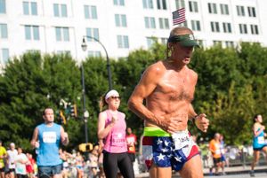 A man wearing American Flag shorts runs by in the Roadrace