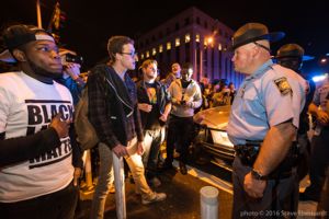 Protesters stand off with Police Officers as they continue their protest