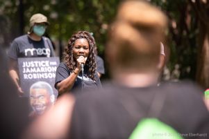Monica Robinson uses a microphone to give a speech
