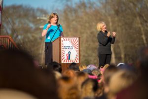 A protester stands at the podium to give a speech to the gathered protesters