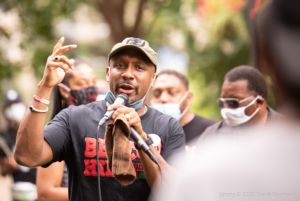 Mawuli Davis speaks to protesters gathered in Woodruff Park