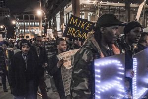 Protesters march through downtown Atlanta holding signs