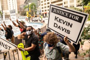A protester holds up a sign calling for 'Justice for Kevin Davis'