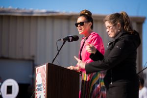 Alyssa Milano speaks to gathered protesters from a podium