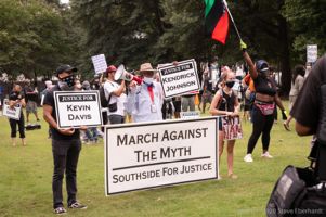 Protesters from the Southside of Atlanta hold up signs