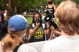 A protester uses a megaphone to speak to other gathered protesters