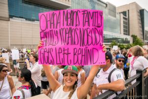 A protester holds up a large sign calling for families to not be seperated