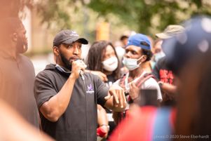 A protester uses a microphone to speak to other protesters