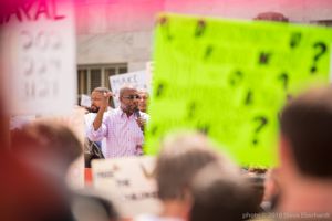 Reverand Raphael Warnock gives a speech to protesters using a microphone