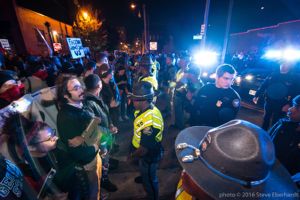 Protesters link arms as they stand off with Police Officers