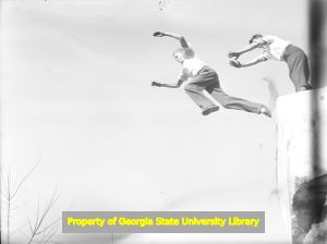 Red Williams and Bud Gedney jumping into the quarry, Tate, Georgia, late 1930s or early 1940s