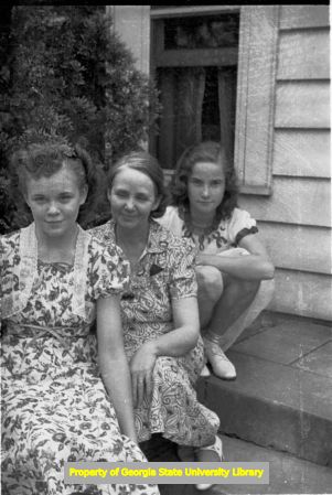Three women sitting on the front steps, Atlanta, Georgia, circa late 1930s or early 1940s