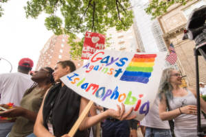 Protesters holding signs, "Gays Against Islamophobia"