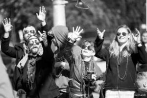 Group reaching for thrown beads