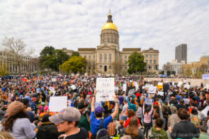 Thousands of protesters stand in front of the GA Capitol building