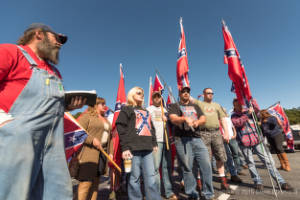 Protesters hold Confederate flags at a rally
