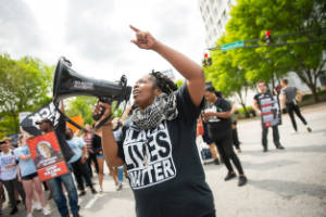 Dawn Oneal speaks to protesters using a megaphone