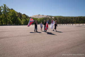 A group of people hold Confederate flags