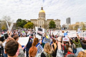 Thousands of protesters stand in front of the Georgia Capitol building