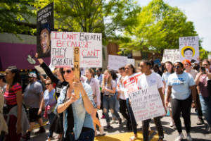 Protesters carry signs in the street