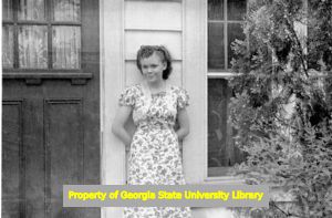 Young woman leaning against a door, Atlanta, Georgia, circa late 1930s or early 1940s