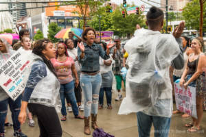 Protesters gather on a sidewalk