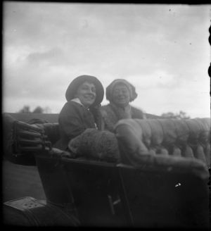 Two women sitting in the backseat of a Ford Model T, circa 1918.