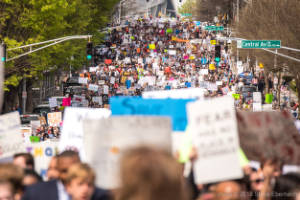 Thousands of protesters are seen in a street