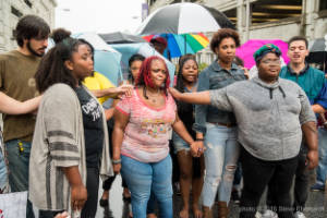 Protesters place their hands on Felicia Christian