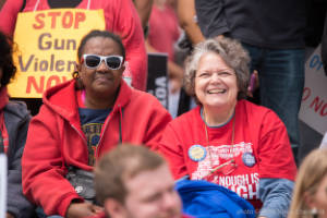 Two protesters are seen in a crowd