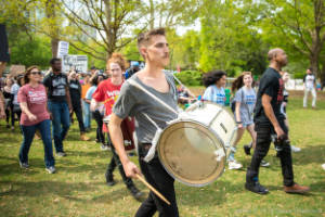 A protester plays a drum in Piedmont Park