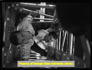 Teenagers climbing the inside of a radio broadcast tower, Atlanta, Georgia, circa late 1930s or early 1940s