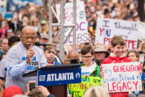 Congressman John Lewis stands next to students as he addresses the crowd