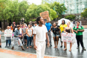 A man speaks to a crowd at a protest