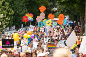 Protesters march with signs painted as pansies