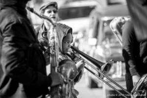 Young boy with Wolfpack plays trombone