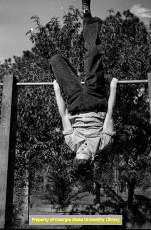 Boy playing on a jungle gym, Atlanta, Georgia, circa late 1930s or early 1940s