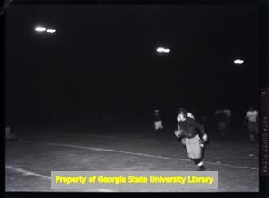 High school football game at night, Atlanta, Georgia, circa late 1930s or early 1940s