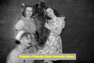 Group of teenagers in costume clowning around at North Fulton High School, Atlanta, Georgia, circa late 1930s or early 1940s