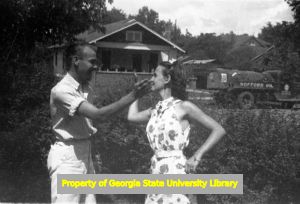 Members of the Lennox family horsing around in the front yard, Atlanta, Georgia, circa late 1930s or early 1940s
