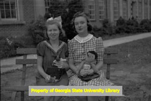 Two teenagers in costume clowning around outside North Fulton High School, Atlanta, Georgia, circa late 1930s or early 1940s
