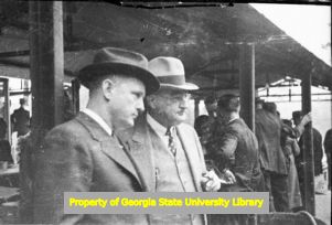 Men relaxing after a meal at an amateur baseball game, Atlanta, Georgia, circa late 1930s or early 1940s