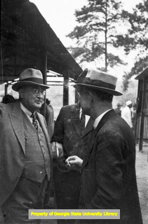 Men relaxing after a meal at an amateur baseball game, Atlanta, Georgia, circa late 1930s or early 1940s