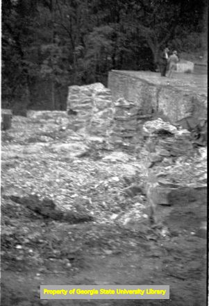 Two men consulting near a cliff, circa late 1930s or early 1940s