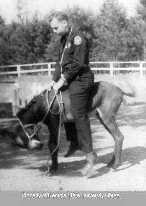 Officer Don riding a donkey