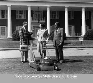 Reporter and lawnmower at White Columns building