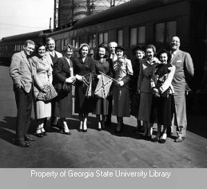 Group with Confederate flags posing in front of Pullman train car