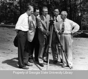WSB management gathered around surveying device