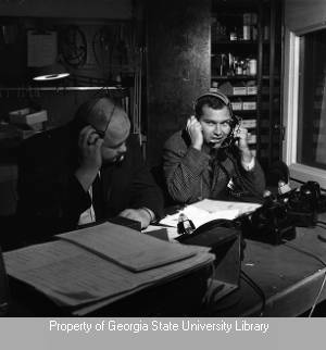 Men at telephone bank during election coverage
